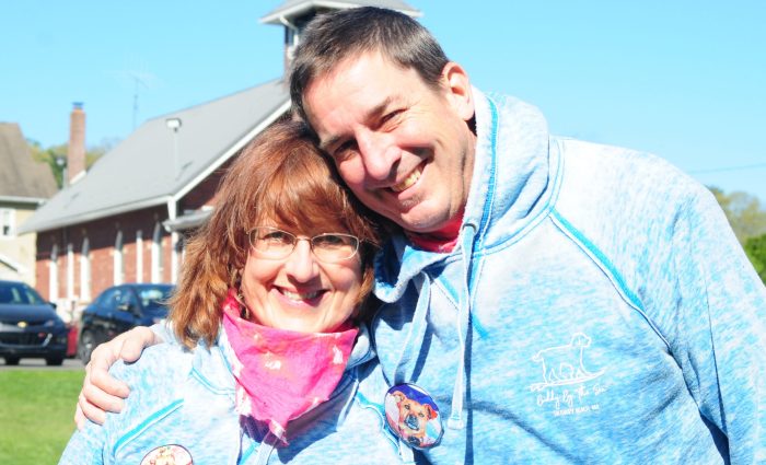 Two volunteers smiling.