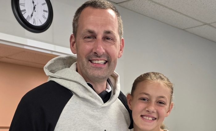 Two volunteers smiling.